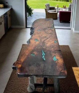 Live-edge wood slab table with turquoise inlay in a bright kitchen