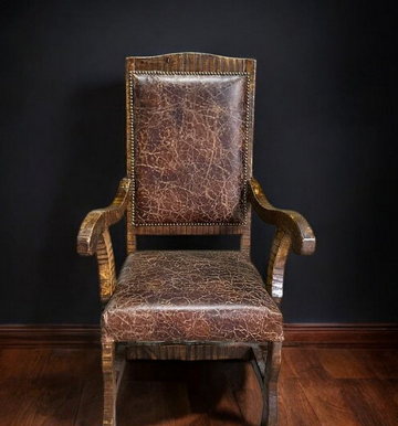 Custom wood-framed armchair upholstered in crackled brown leather with nailhead trim