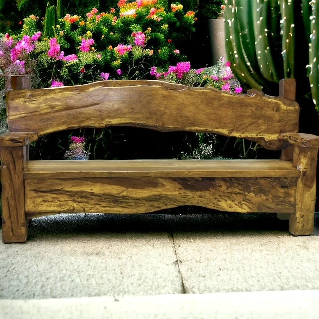 Live-edge wood bench with a sculpted back among flowering plants and cactus
